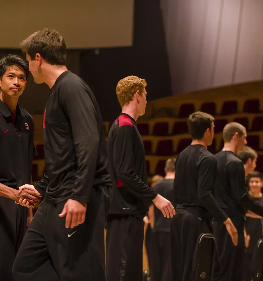 Volleyball players shake hands as part of Ann Carlson&#39;s The Symphonic Body: Stanford at the Performance Studies International 19 conference, June 2013. Photo by Toni Gauthier.